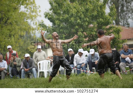 BURSA,TURKEY-MAY 13: Unidentified wrestlers participate in the annual oil wrestling championship on May 13,2012 in Bursa.Oil wrestling is considered as an ancestral sport in Turkey.