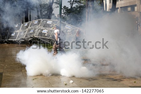 ISTANBUL,TURKEY-JUNE 1:Police attack Taksim protesters with tear gas and water cannons on june 1, 2013 in Istanbul,Turkey.Clashes continued all day between police and demonstrators.