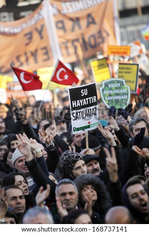ISTANBUL,TURKEY-DECEMBER 22:Thousands protest against corruption and government on 22 December, 2013 in Istanbul, Turkey.A protester holds a placard reads\