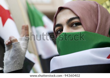 ISTANBUL,TURKEY-FEBRUARY 5: An unidentified woman participates with a group of people who staged a demonstration in front of the Syrian Consulate, protesting Syrian authorities\' violent crackdown in Homs, on Feb 5, 2012 in Istanbul, Turkey