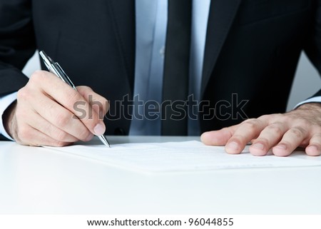 Close up of human hands signing a contract