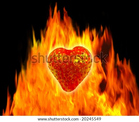 Composition of a heart shaped strawberry in front of a fire over black background. Very detailed strawberry structure with seeds.