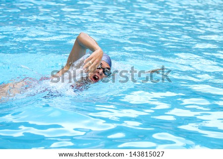 Front crawl swimmer in pool