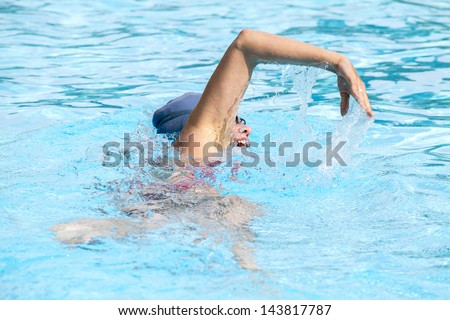 Front crawl swimmer in pool