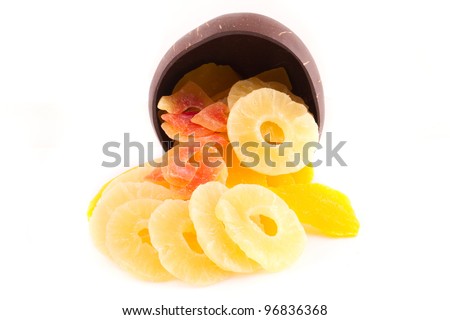 mix of dried pineapple, mango and papaya in the wooden plate