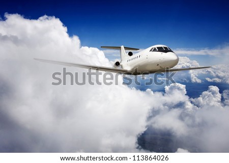 Private jet plane in the blue sky.