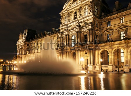 PARIS - SEPTEMBER 25: Louvre museum at night on September 25,2013. Louvre museum is one of the world\'s largest museums with more than 8 million visitors each year.