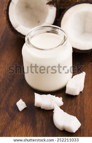 Coconut Milk in a glass on dark wooden background