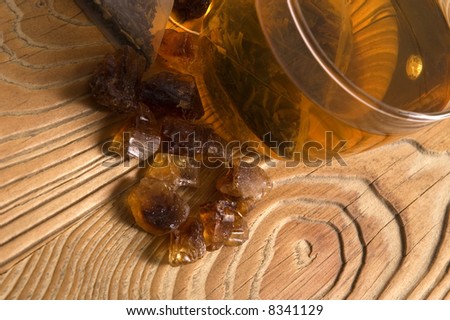 white tea, nylon tea-bag and brown sugar on the old wood