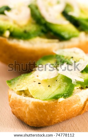 Sandwich with avocado on a wooden board