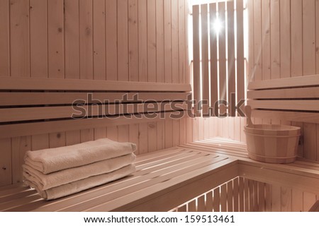 Detail of bucket and  towels in a wooden sauna room