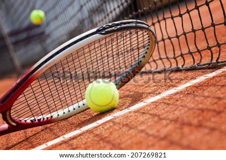 tennis racket and ball on the clay tennis court