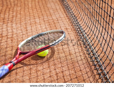tennis racket and tennis ball on the clay court