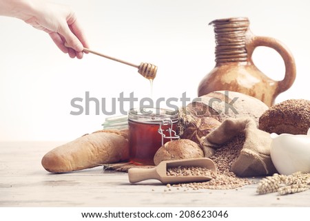 vintage jug, bread and  seeds,honey, isolated on white