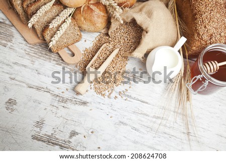 Freshly baked bread rolls, wheat ears and honey