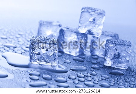ice cubes and water drops on blue background