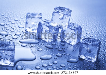 ice cubes and water drops over blue background
