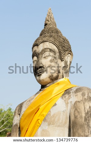 Stone Buddhist statue with gold material decoration Thailand