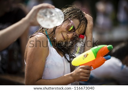 SAMARA,RUSSIA-JULY 22 2012: young unidentified people in the street shooting and throwing water at each other during Water Wars flashmob,July 22, 2012,Samara, Russia