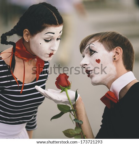 couple of  mime with red rose