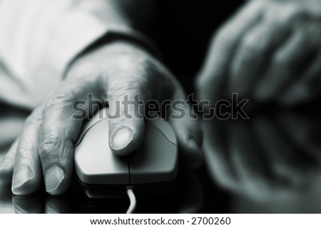 work on the pc (hand of the man with computer mouse,focus point on the finger,special tone photo f/x)