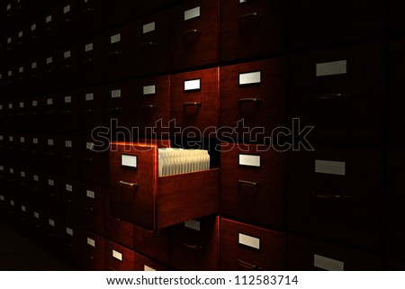 Open file drawer in a dark room filled with file cabinets