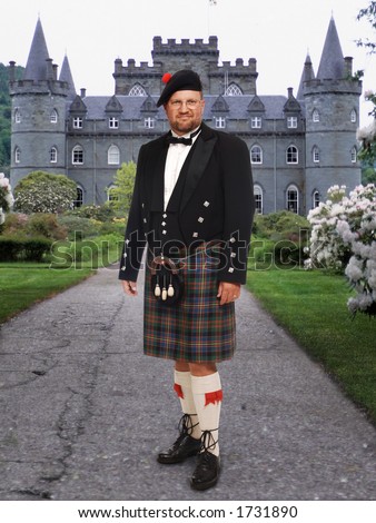 Scottish highland man in kilt in front of Inverary Castle