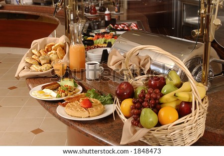 breakfast buffet with eggs, waffles, fruit and coffee