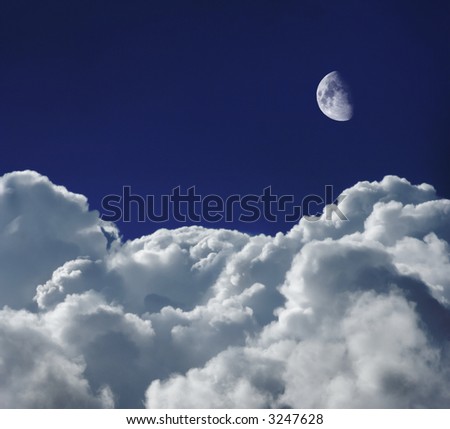 Cumulus clouds shot from a high altitude against an indigo  blue sky with the moon above