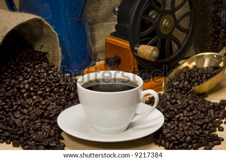 Coffee cup propped with coffee accessories in a landscape format