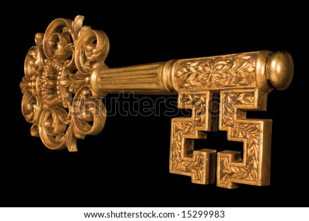 Ornate gold key at an angle on black