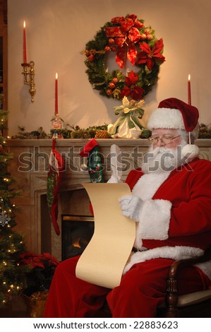 Santa sitting near the fireplace checking the list of good boys and girls