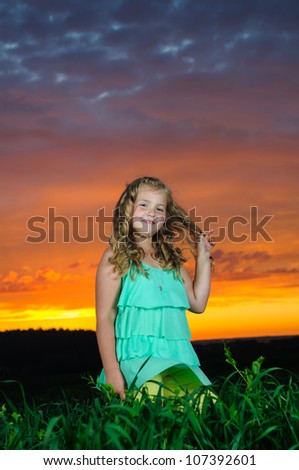 happy young girl rest on green field after the storm