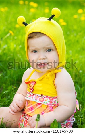 Happy little girl  on the meadow with yellow flowers