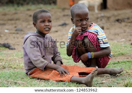 MAASAI MARA, KENYA - NOVEMBER 10: Portrait of unidentified Maasai children on November 10, 2012 in Maasai Mara, Kenya. Maasai are a Nilotic ethnic group of semi-nomadic people located in Kenya