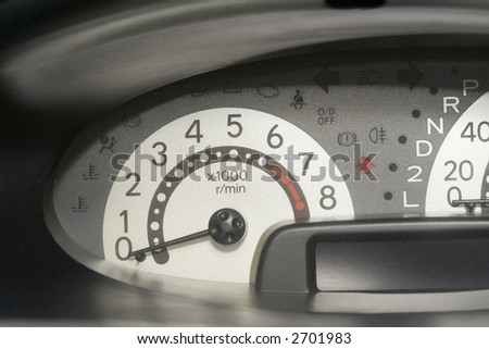 Car dashboard showing the speedometer with the needle pointing at zero