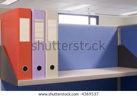Shelf in an office cubicle with some files