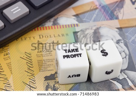 Australian currency with calculator and dice showing TAKE PROFIT