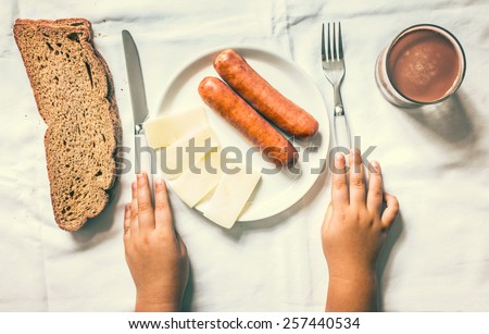 Breakfast on table with kids hands