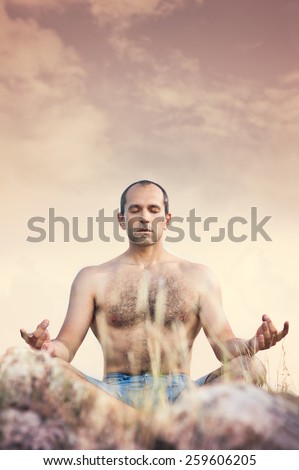 Man in nature meditate in lotus position