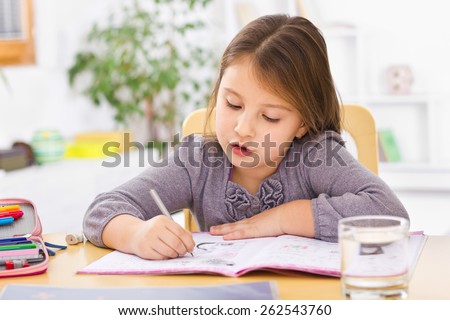 Little kid at home doing homework