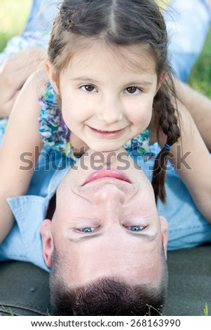 Young father and daughter portrait relaxing nature