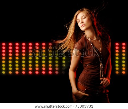 pretty girl with long fluttering hair dancing on background with color lights