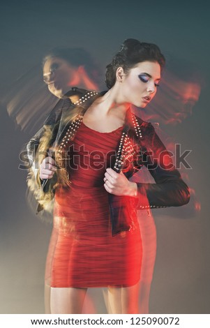 Fashion portrait of one beautiful woman in mixed light