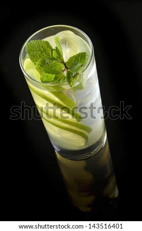lemonade with lime and ice on a black background