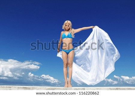 Beautiful Girl With White Scarf over blue sky. Travel and Vacation. Freedom Concept