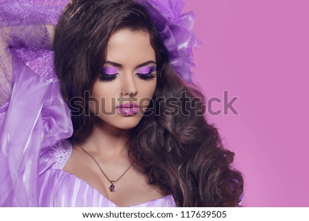 Beautiful woman with curly hair and bright make-up. Jewelry and Beauty. Fashion art photo