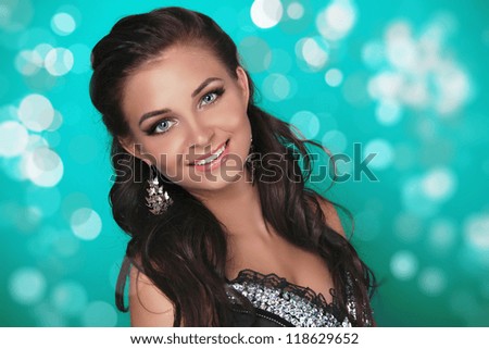Young beautiful teen with smile, green holiday light background