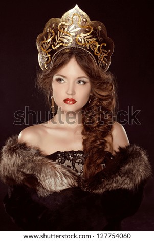 Russian Beauty. Attractive female wearing in kokoshnik. Woman's headdress in old Russia