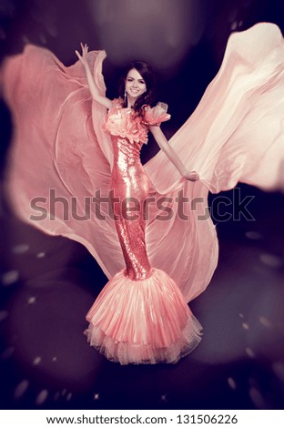 Beautiful Girl in Blowing Dress Flying. Fashion lady in luxury dress